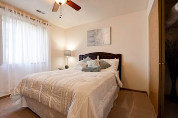 Carpeted Bedroom With Ceiling Fan & Light